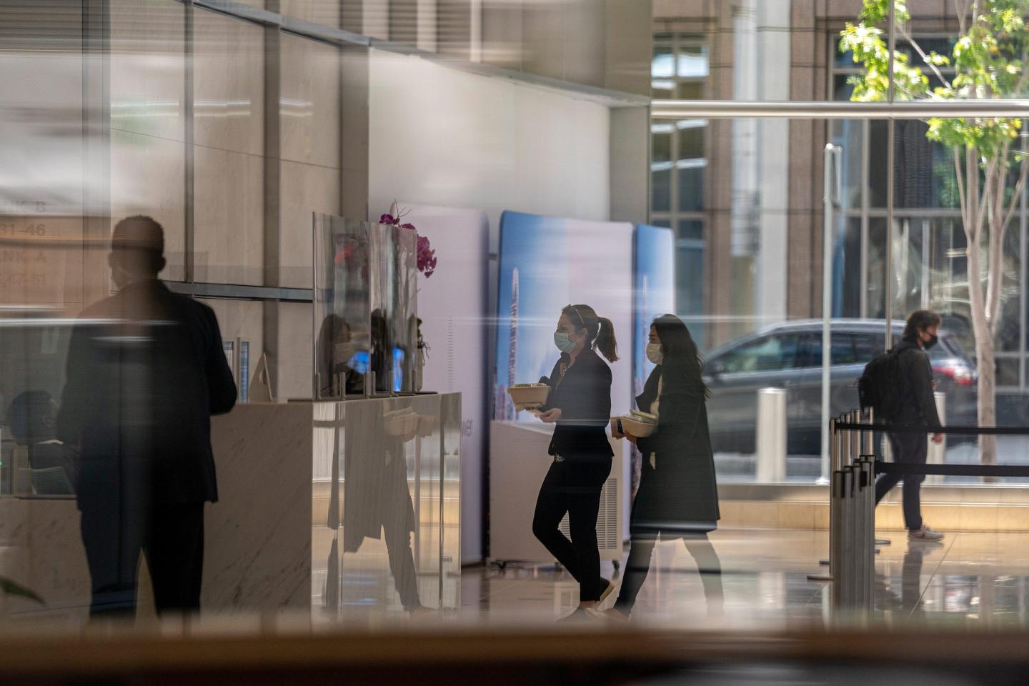 People walking past an office building in San Francisco