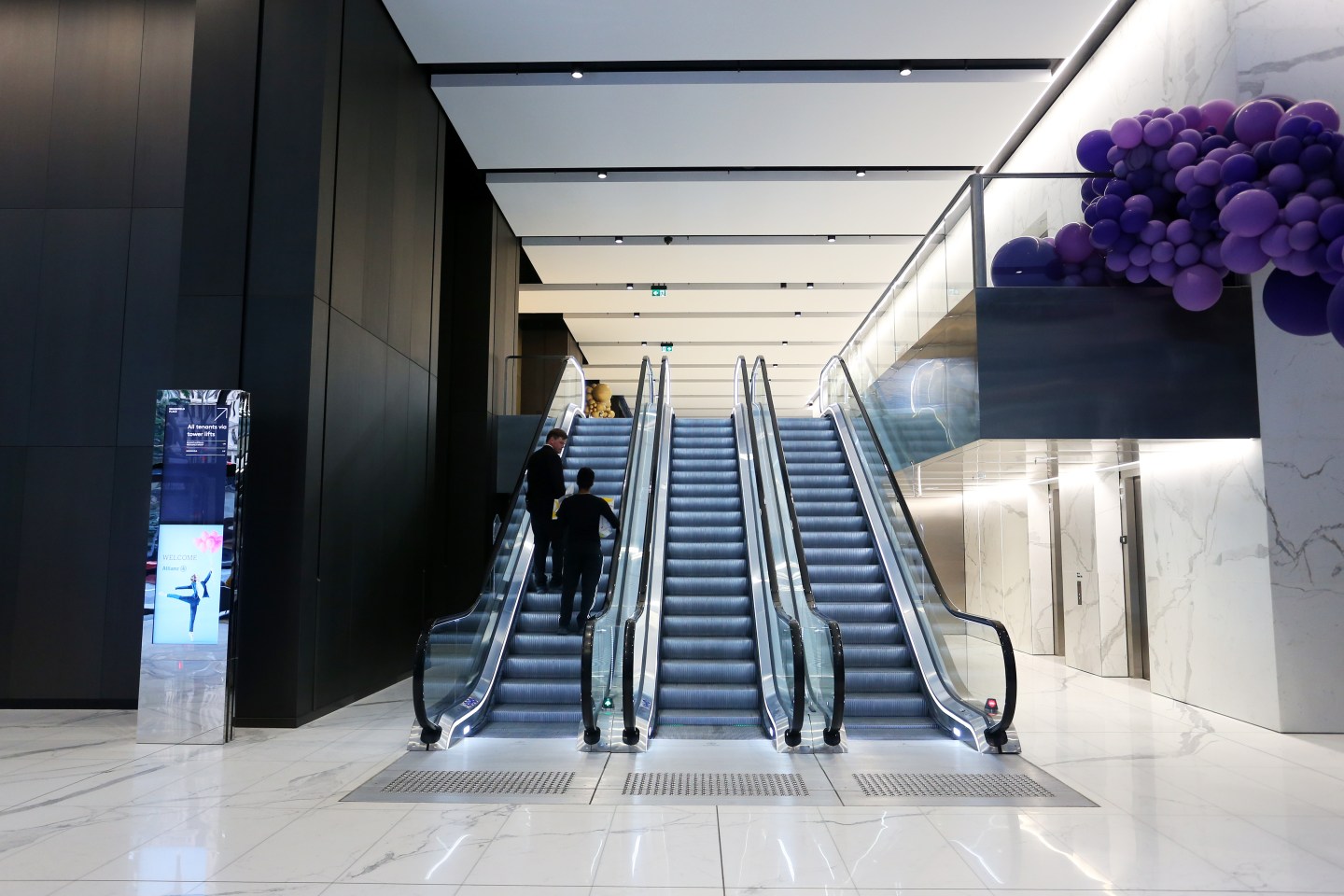 People use an escalator in the main foyer at the Brookfield Place Sydney office building, owned and home to the Asia-Pacific headquarters of Brookfields Asset Management Inc., in Sydney, Australia, on Thursday, June 17, 2021.