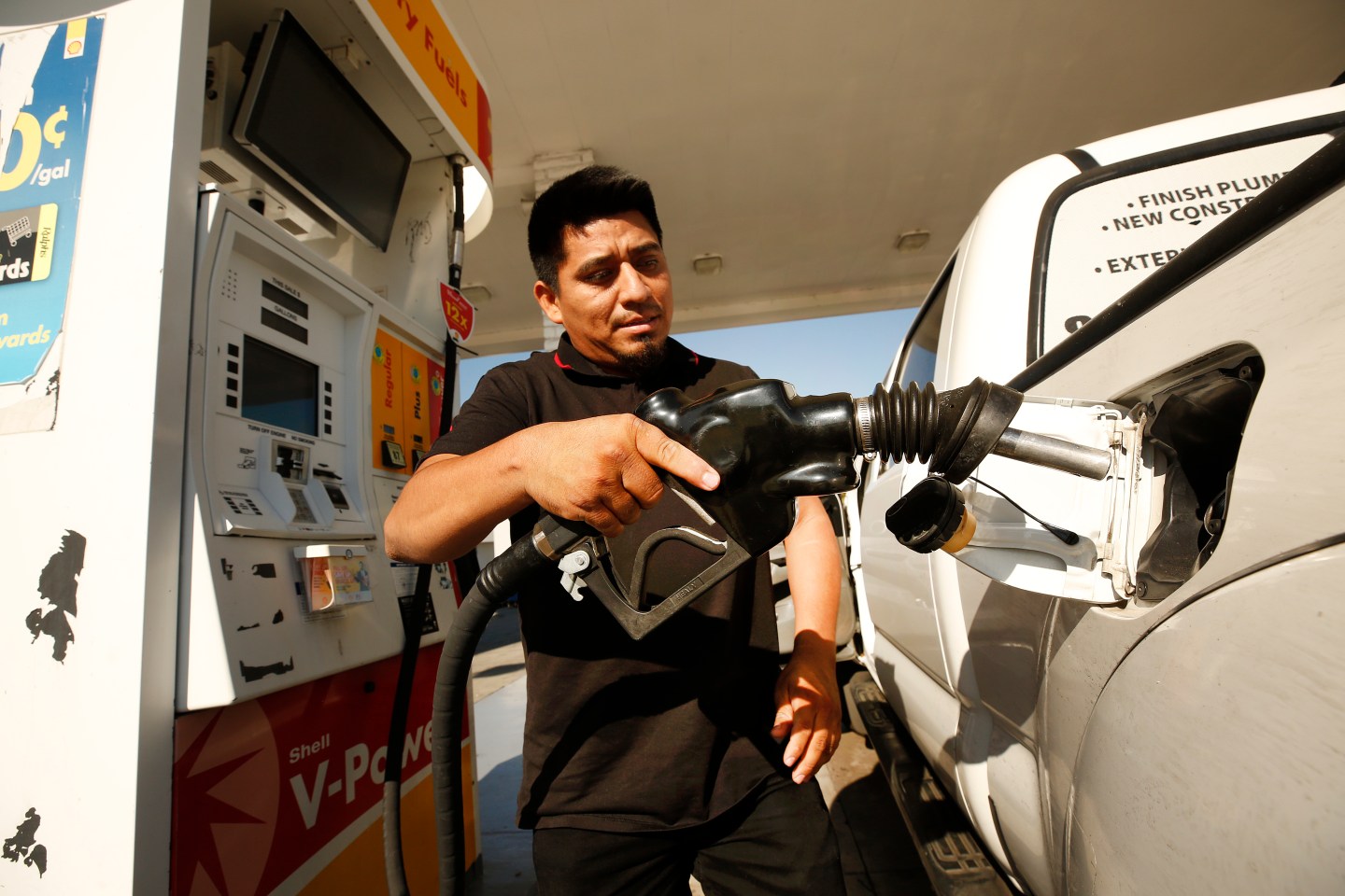 Man filling up his gas tank.