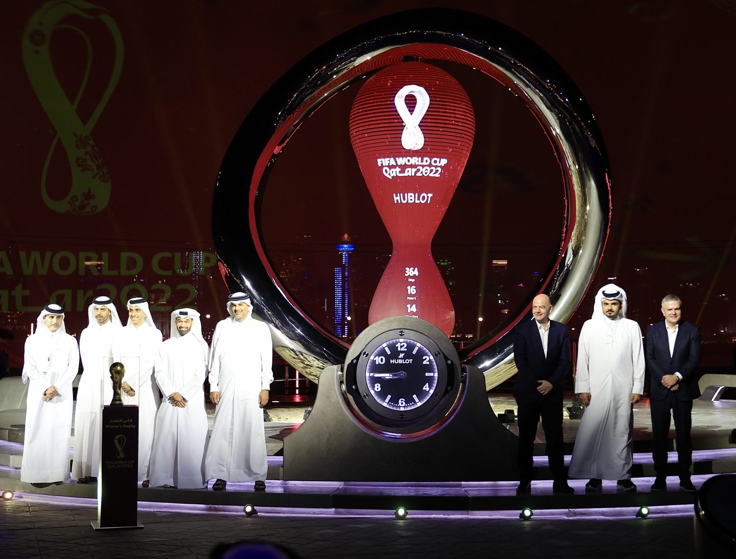 Men standing around statue