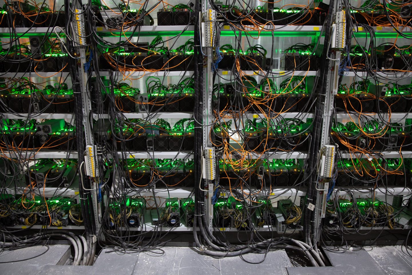 Power and ethernet cables connected to mining rigs at the Minto cryptocurrency mining center in Nadvoitsy, Russia