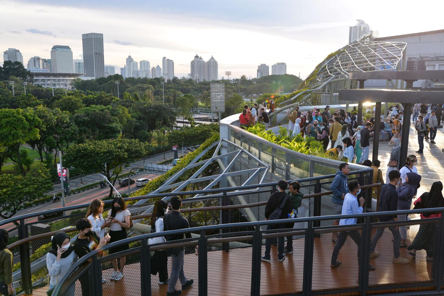 People stroll along the skywalk of Senayan Park in Jakarta, Indonesia, on Jan. 23, 2022.