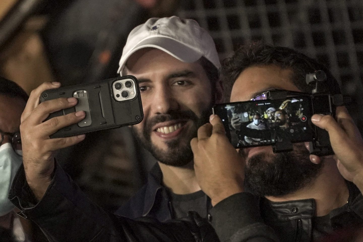 Nayib Bukele, president of El Salvador, takes a selfie with a government worker