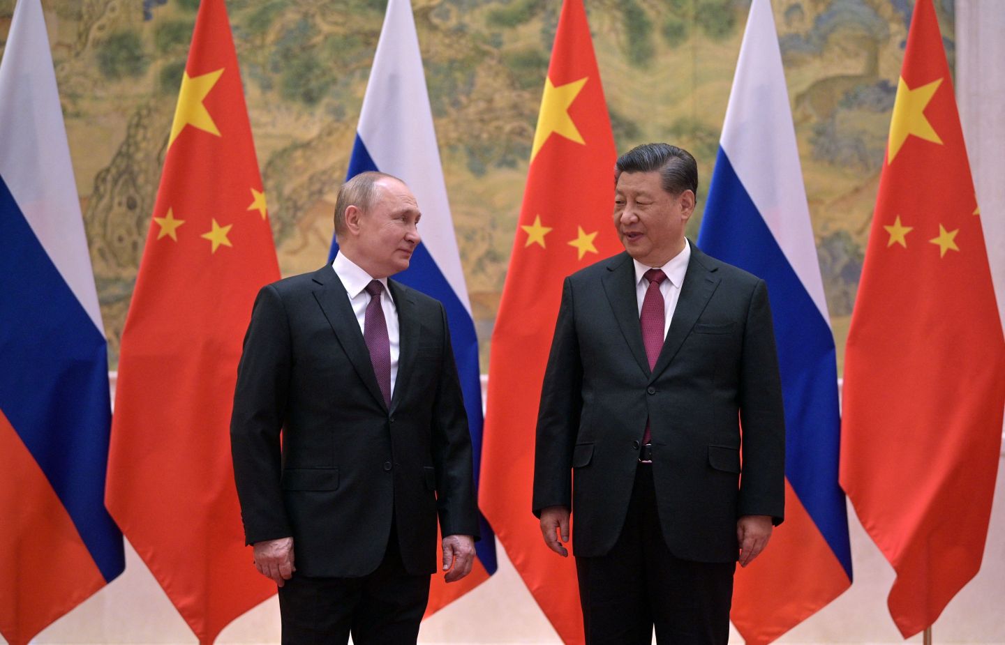 Russian President Vladimir Putin (L) and Chinese President Xi Jinping pose during their meeting in Beijing, on February 4, 2022.