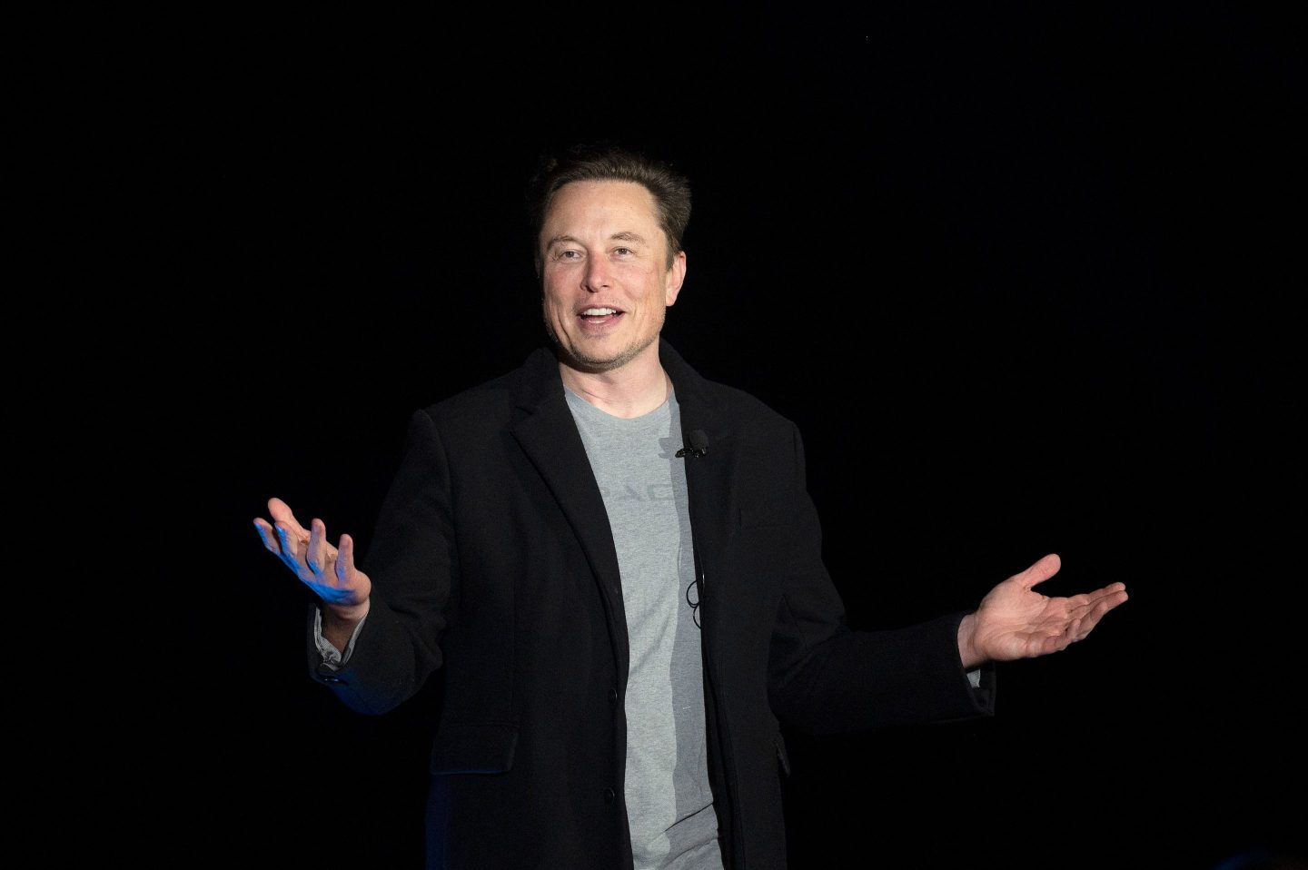 Elon Musk gestures as he speaks during a press conference at SpaceX's Starbase facility