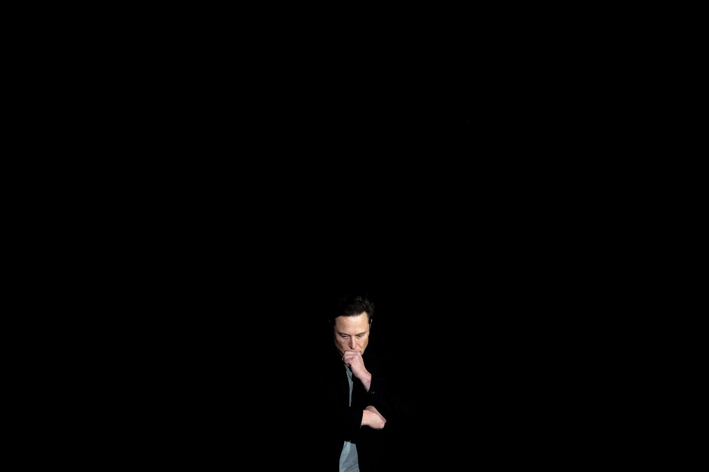 Elon Musk pauses and looks down as he speaks during a press conference at SpaceX's Starbase facility near Boca Chica Village in South Texas on Feb. 10, 2022. Musk has been publicly mum on Twitter users' requests that he disable Teslas in Russia.