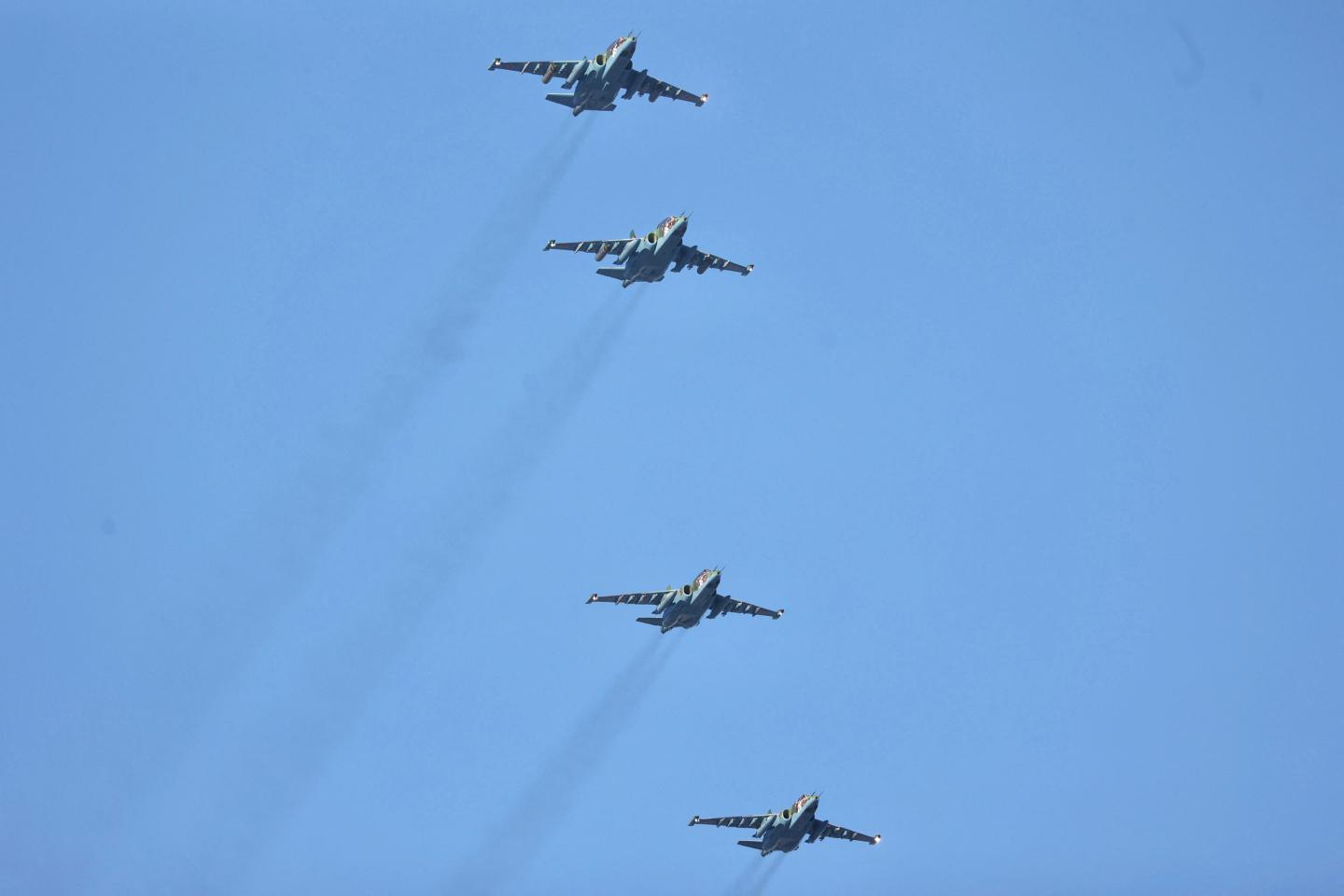 Four fighter jets fly in the sky.