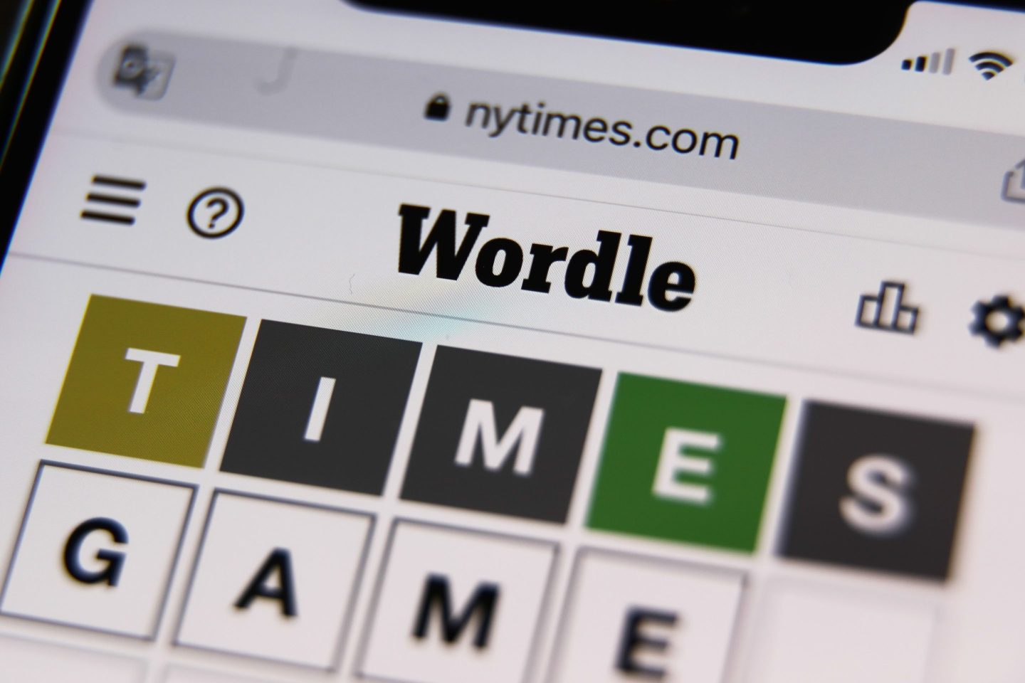 A phone screen showing the game, Wordle, on New York Times' website