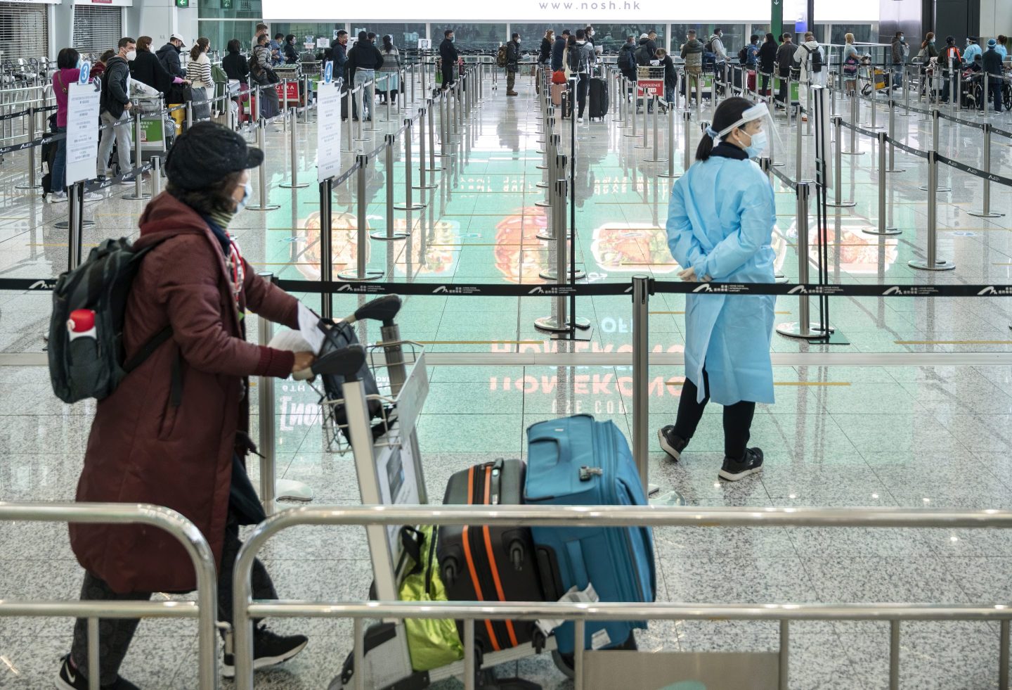 Passengers wait in a line at arrival hall as they need to go