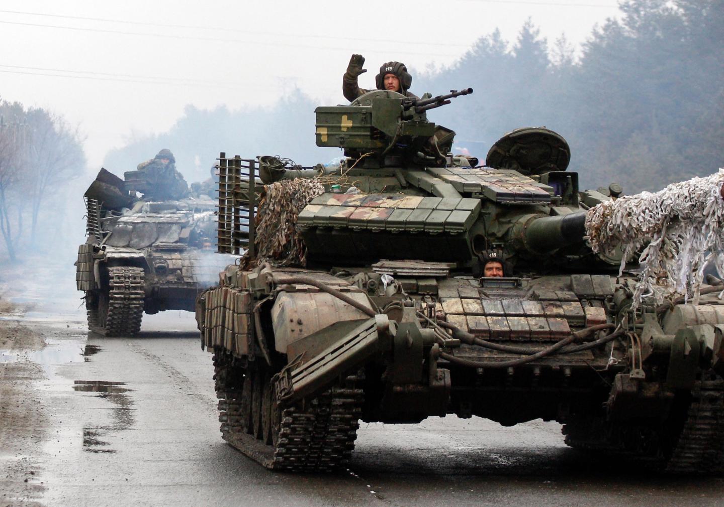 Ukrainian servicemen ride on tanks towards the front line with Russian forces in the Lugansk region of Ukraine.