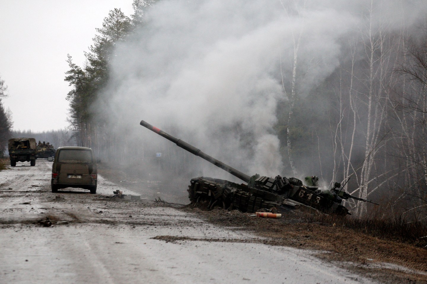 Smoke rises from a Russian tank destroyed by the Ukrainian forces on the side of a road in Lugansk region on February 26, 2022.
