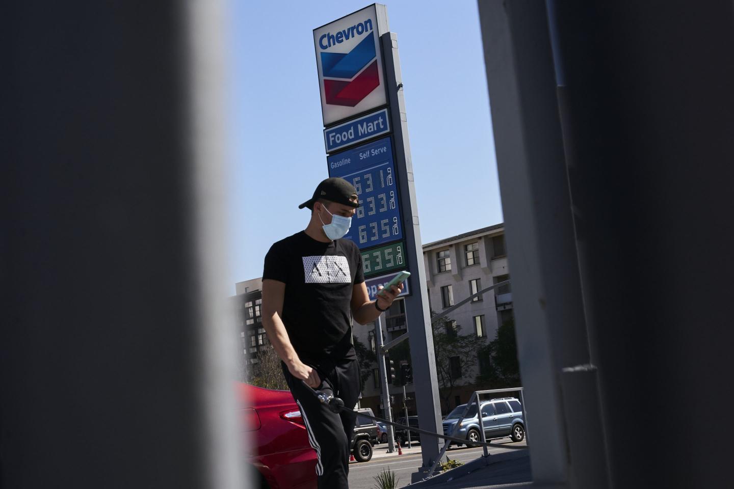 Signage with fuel prices outside a Chevron gas station