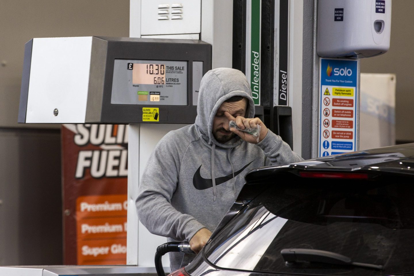 Man fills his car up with gas in Belfast