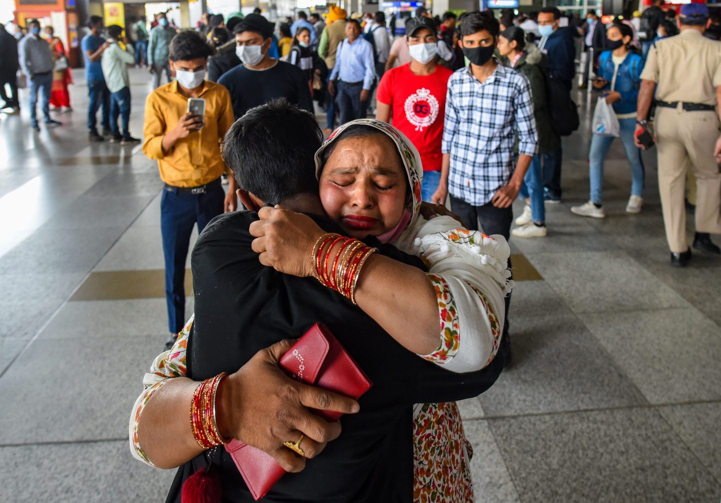 Woman hugs student at airport