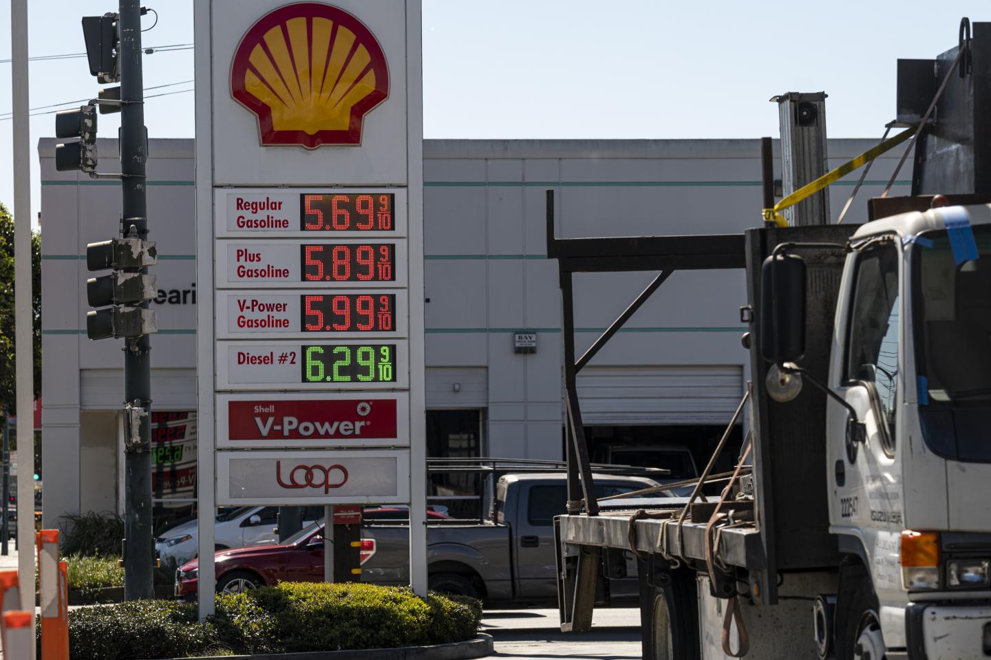 Signage displaying fuel prices at a Shell gas station in San Francisco.