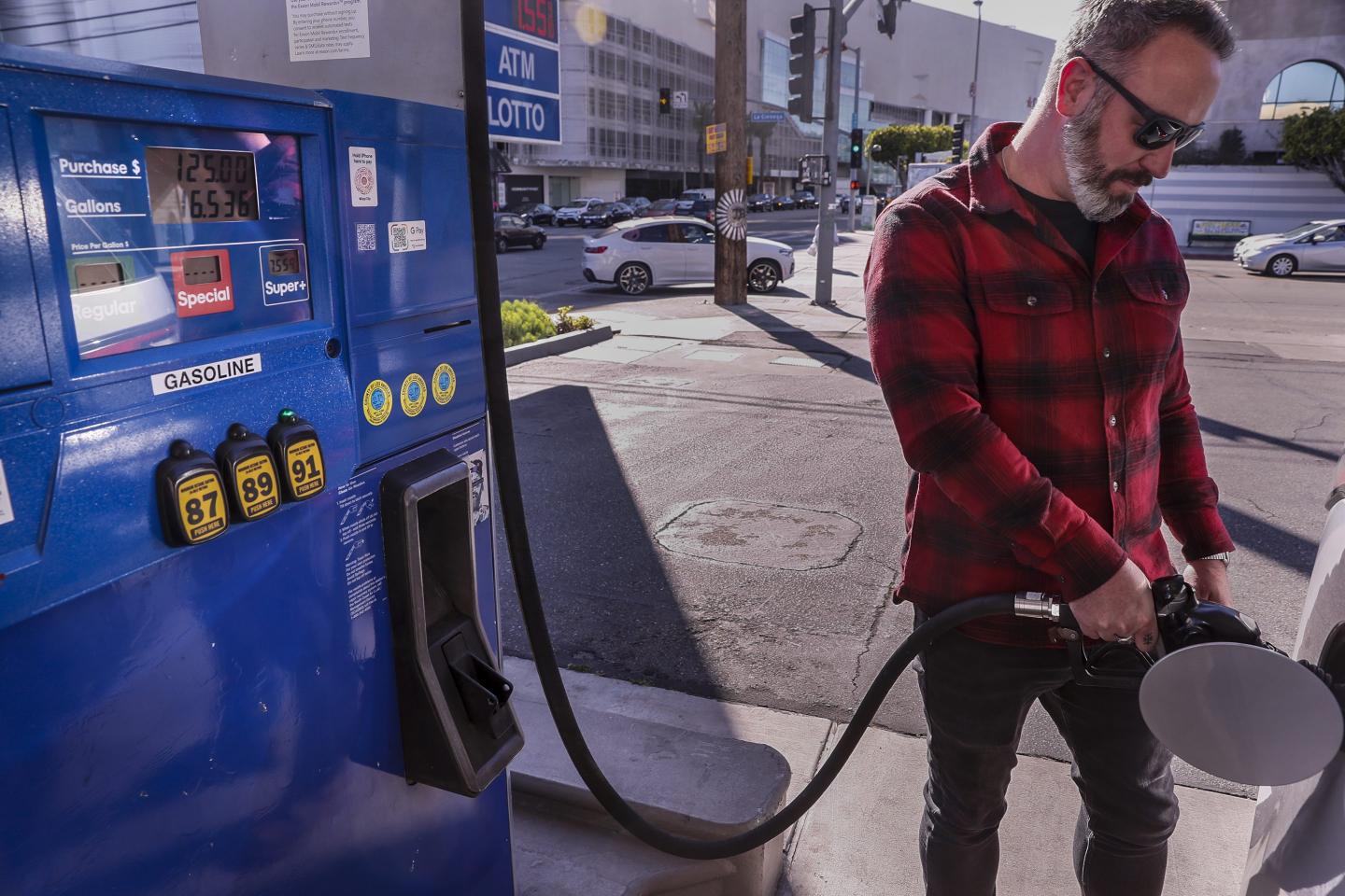 Man fills his SUV with gas