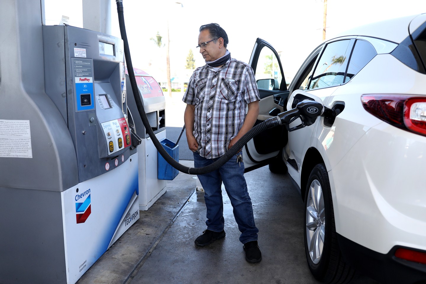 A man pumps gas.