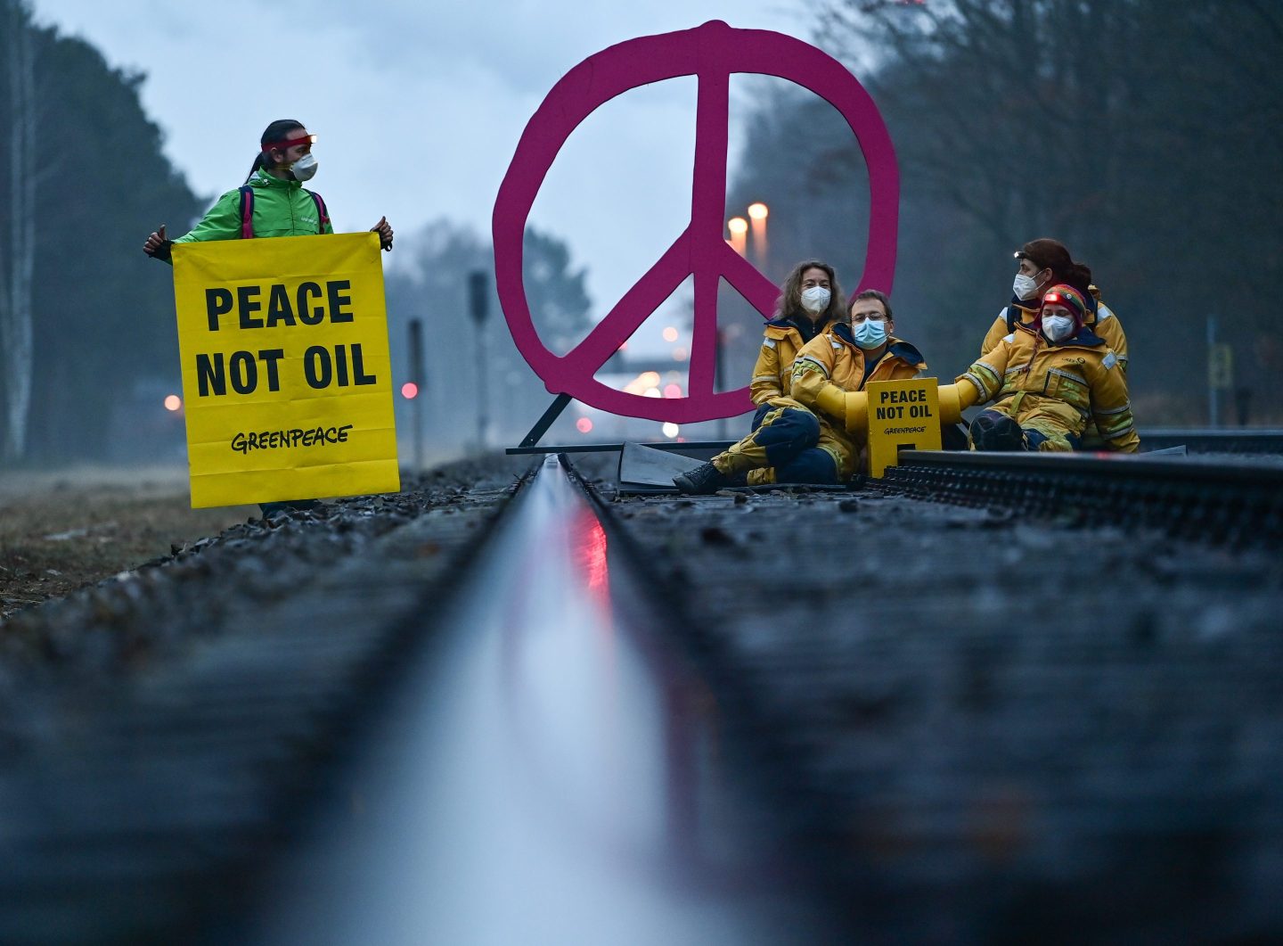 Greenpeace activists on March 15 block a rail track leading to a major oil refinery in Schwedt, Germany, where crude oil arrives from Russia via the "Friendship" pipeline.