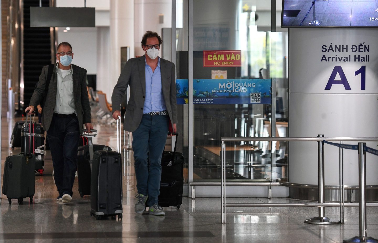 Two passengers leave the Hanoi international airport