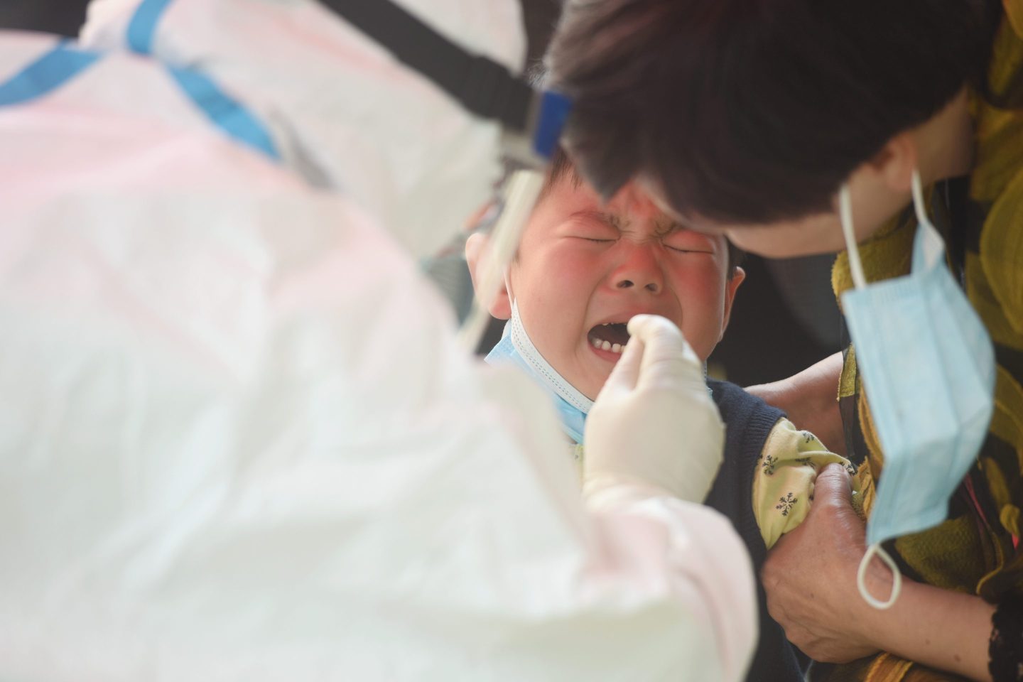 Child in China gets PCR throat swab test.