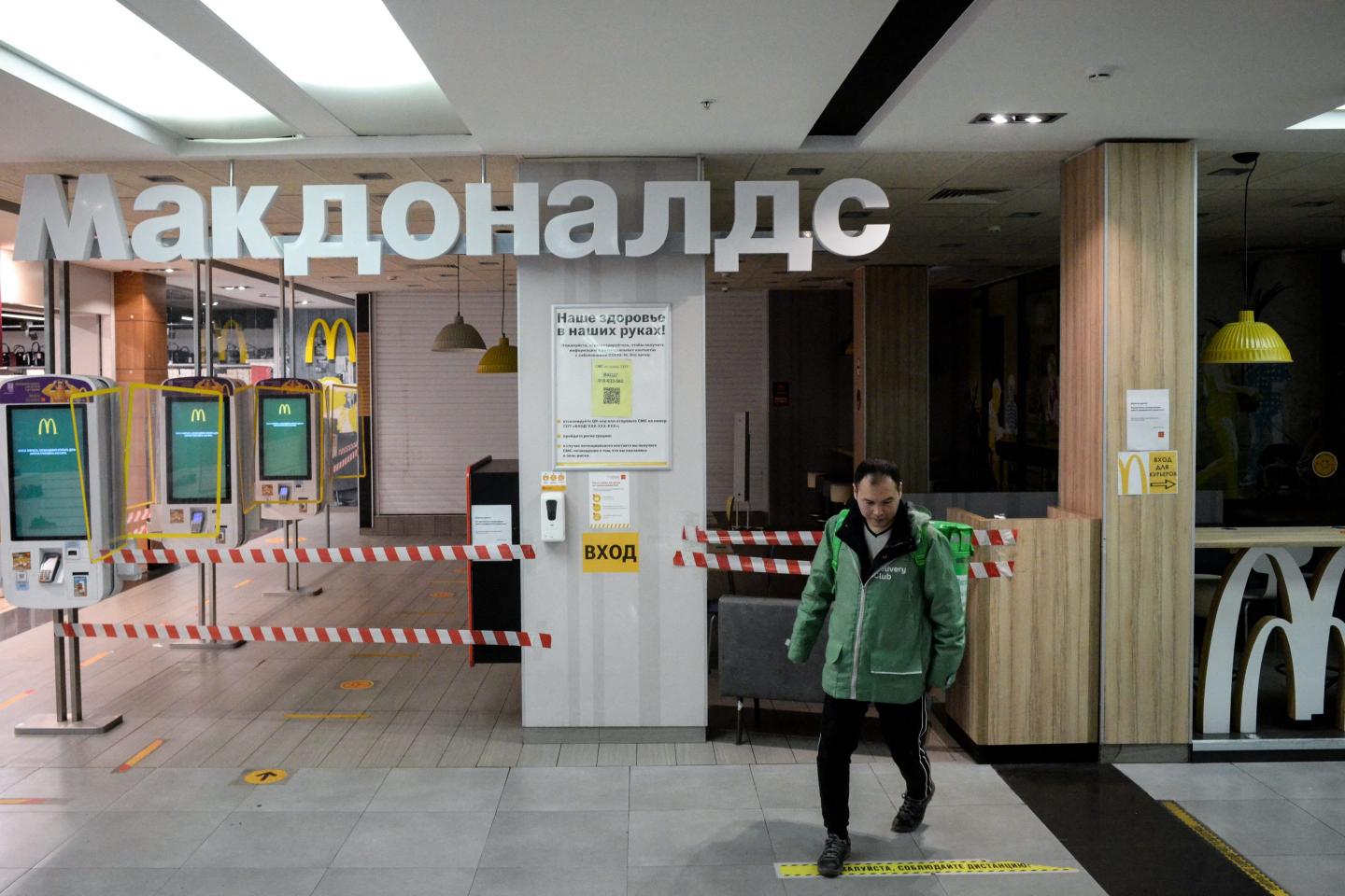 A man walks by a closed McDonald's in Moscow.