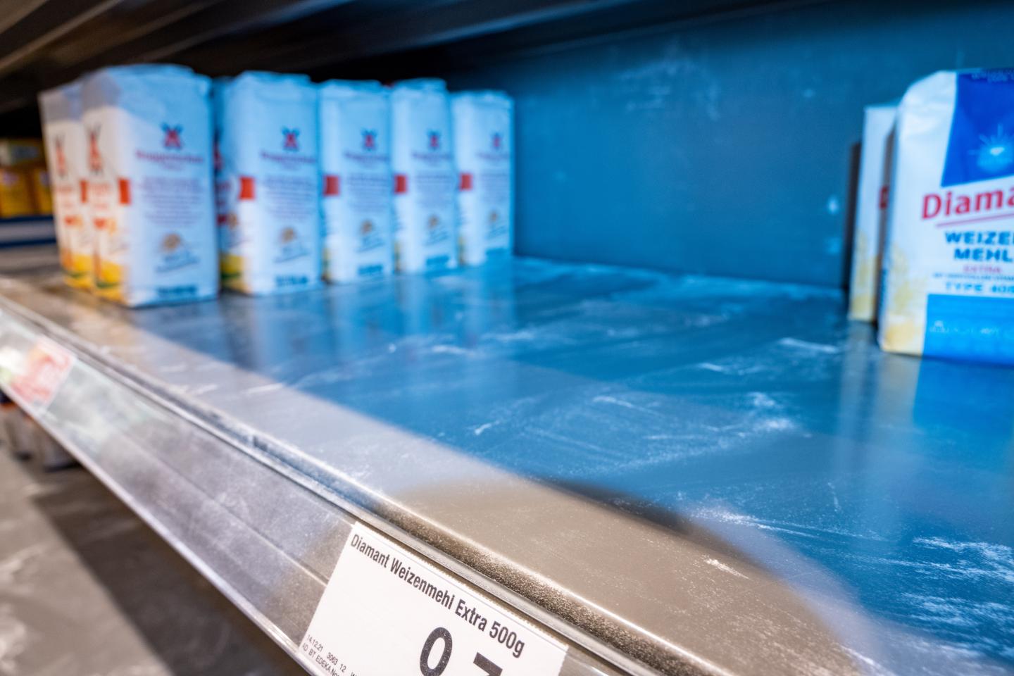An empty shelf of flour at a grocery store in Germany.