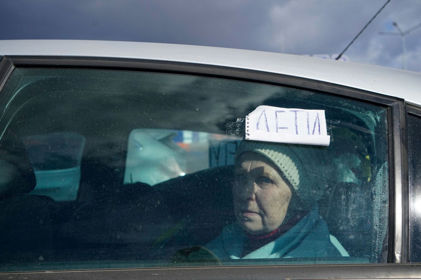 Evacuees from Mariupol are seen upon arrival at the car park of a shopping centre on the outskirts of the city of Zaporizhzhia, which is now a registration centre for displaced people, on March 16, 2022.