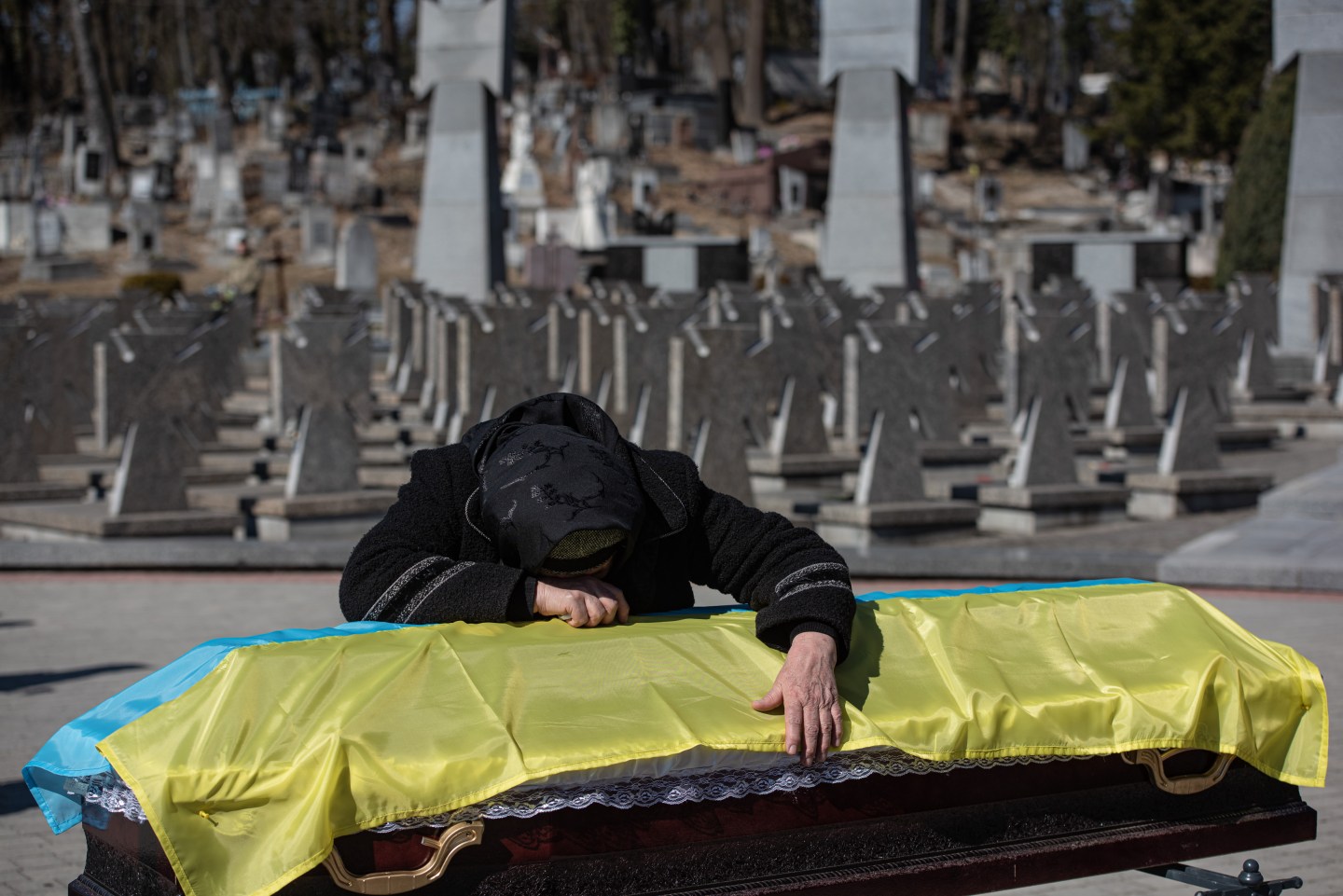 The mother of Ukrainian officer Ivan Skrypnyk cries over the coffin with the body of her son, during the funeral ceremony on March 17 in Lviv, Ukraine. The soldier died in Sunday's airstrike on the nearby International Center for Peacekeeping and Security at the Yavoriv military complex. The barrage of Russian missiles killed 35 and wounded scores. The site, west of Lviv in the town of Starychi, is mere miles from Ukraine's border with Poland.