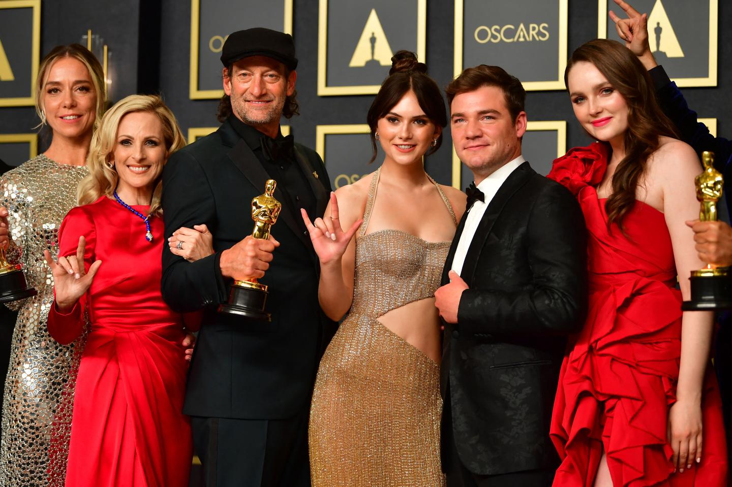 The cast of CODA hold their award for Best Picture.