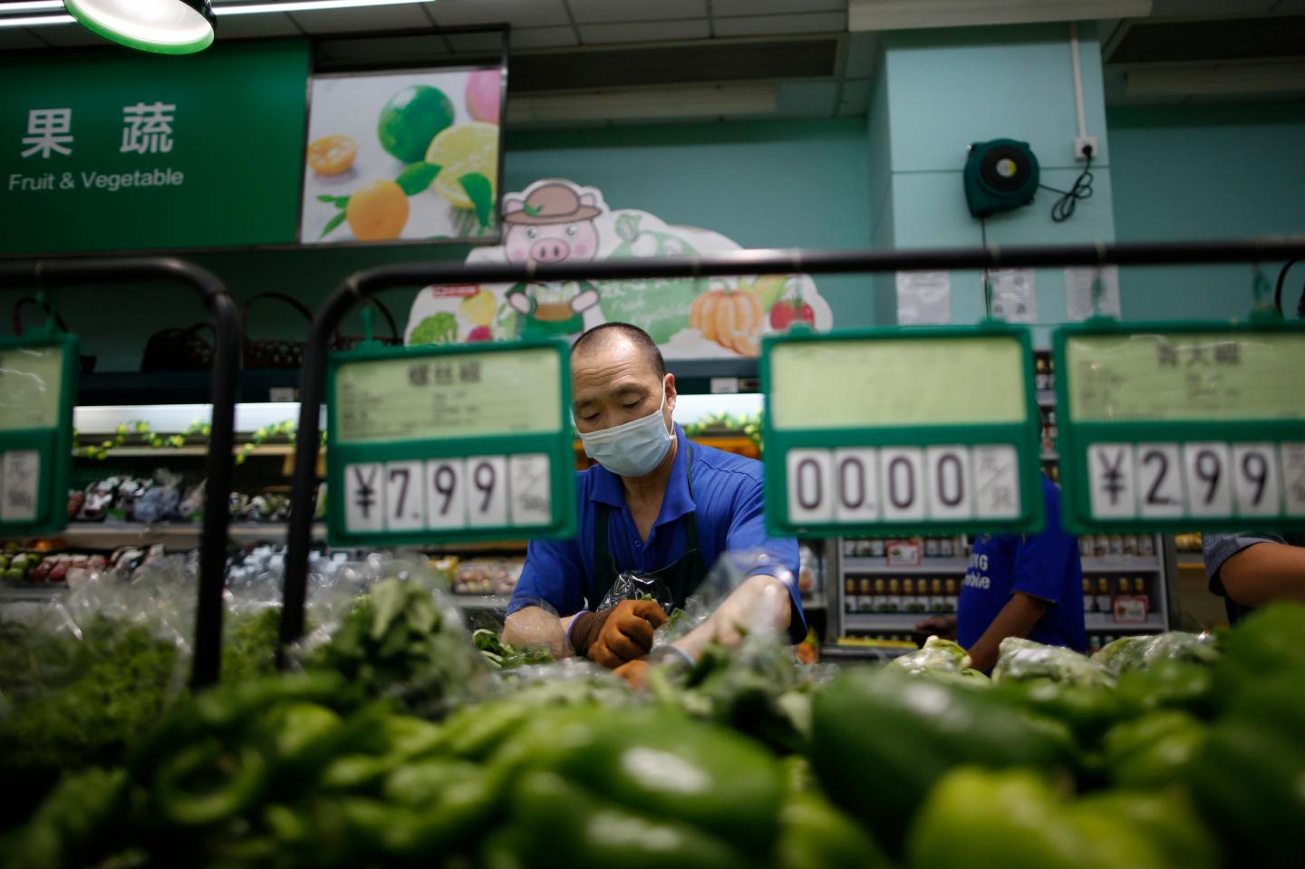 People shop for vegetables at a supermarket on June 19, 2020, in Beijing, China.