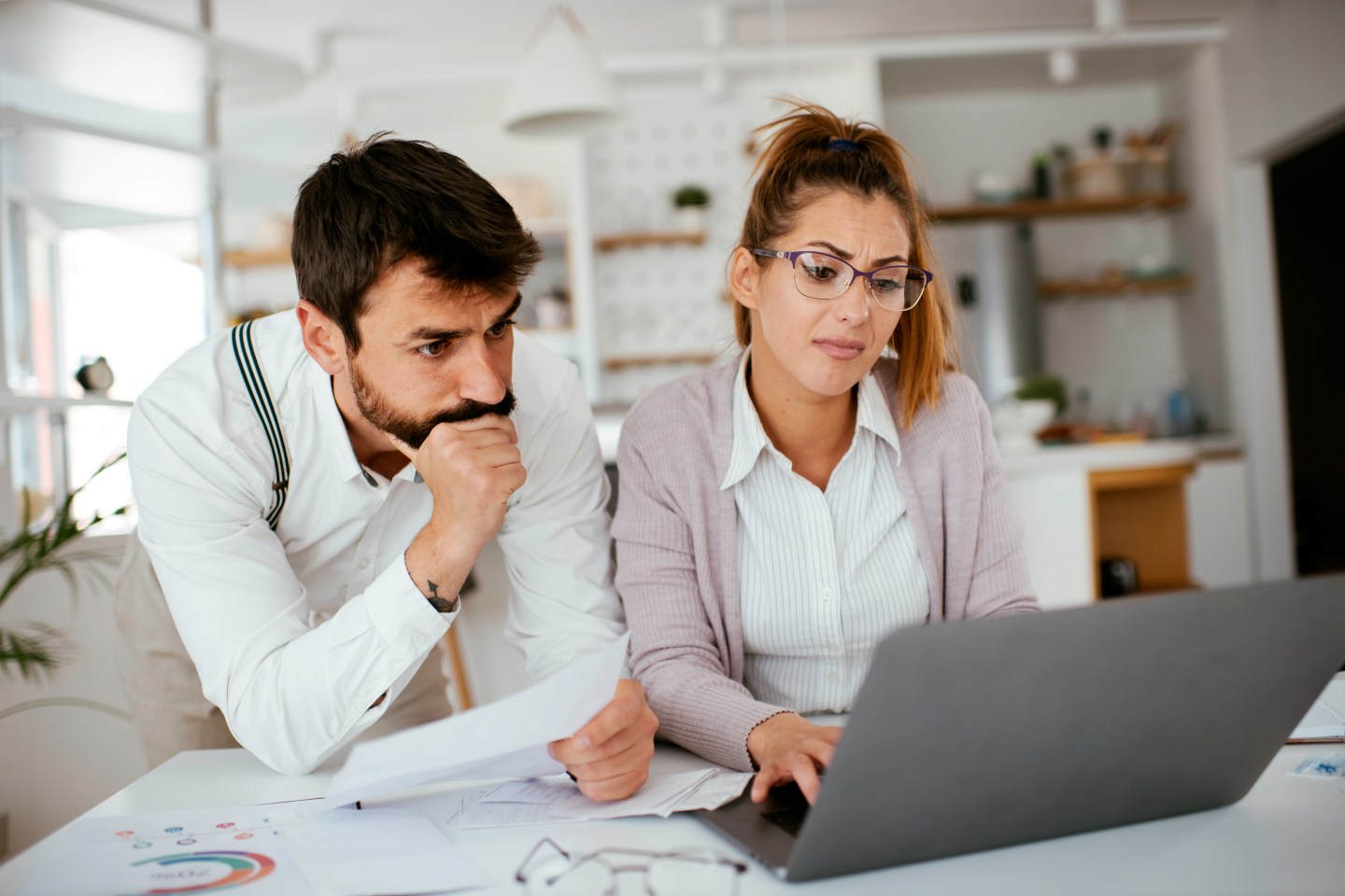Worried young couple with bills