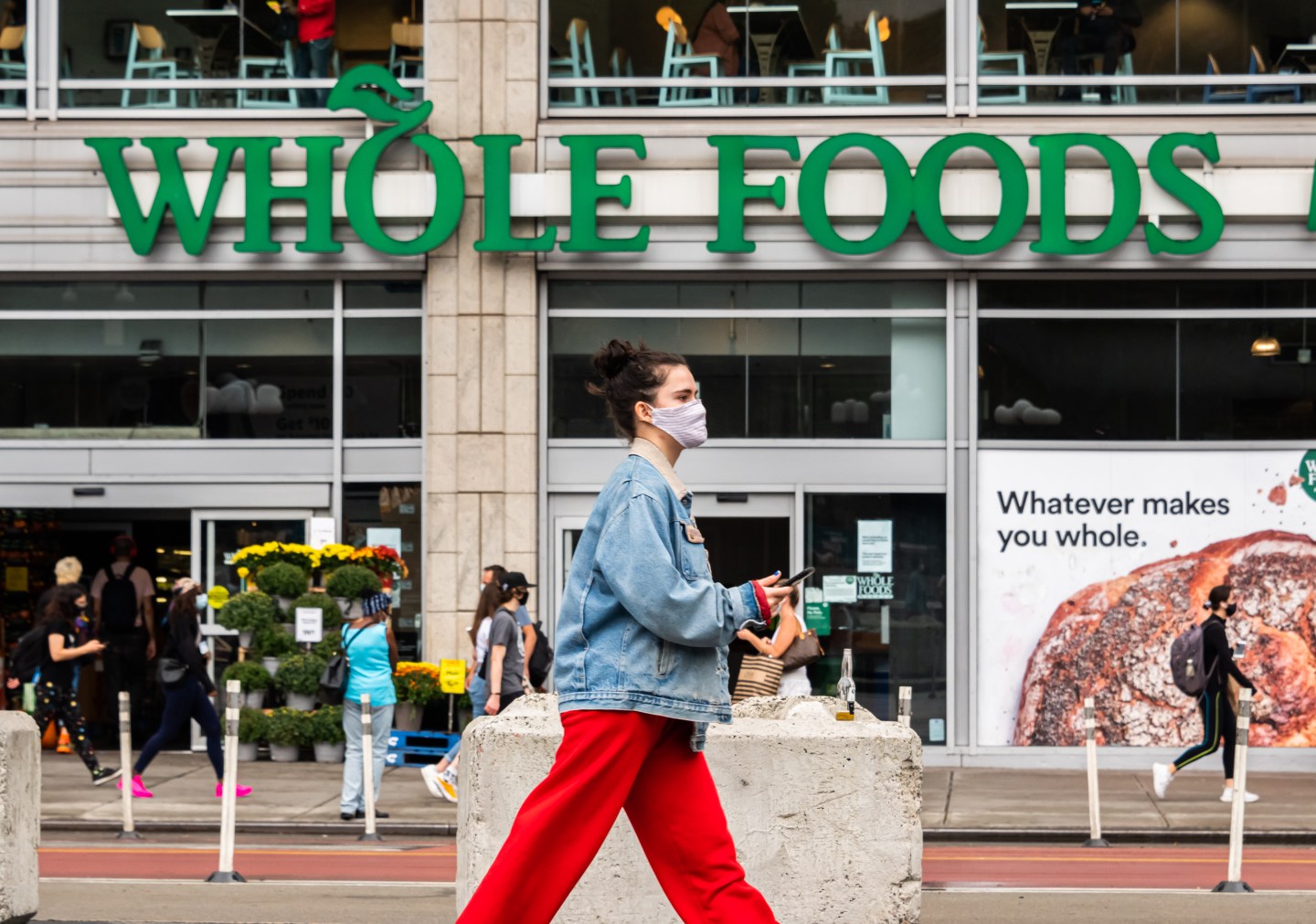 A person wears a face mask outside Whole Foods Market in New York's Union Square.
