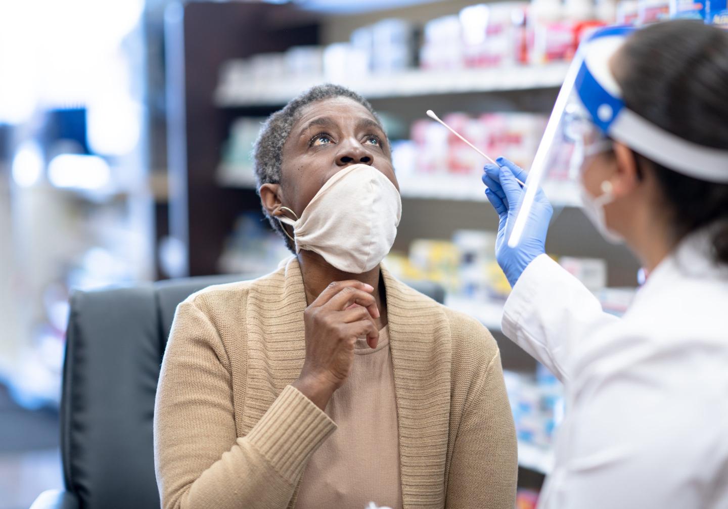 Woman gets COVID-19 test at pharmacy