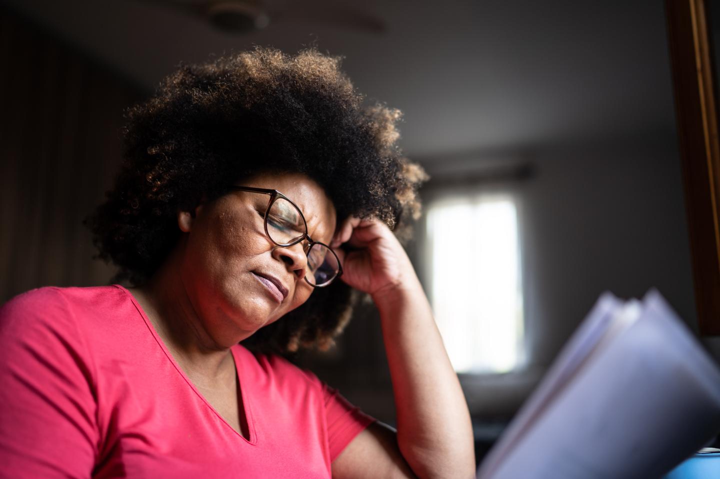 worried woman looking at bills