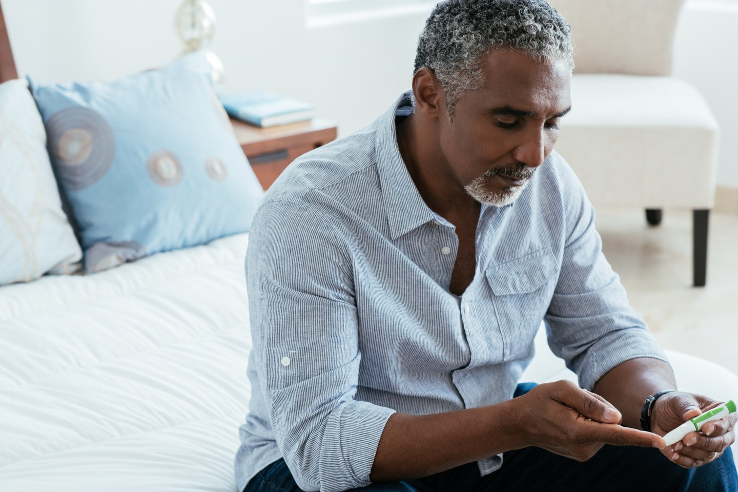 A man checking his blood sugar.