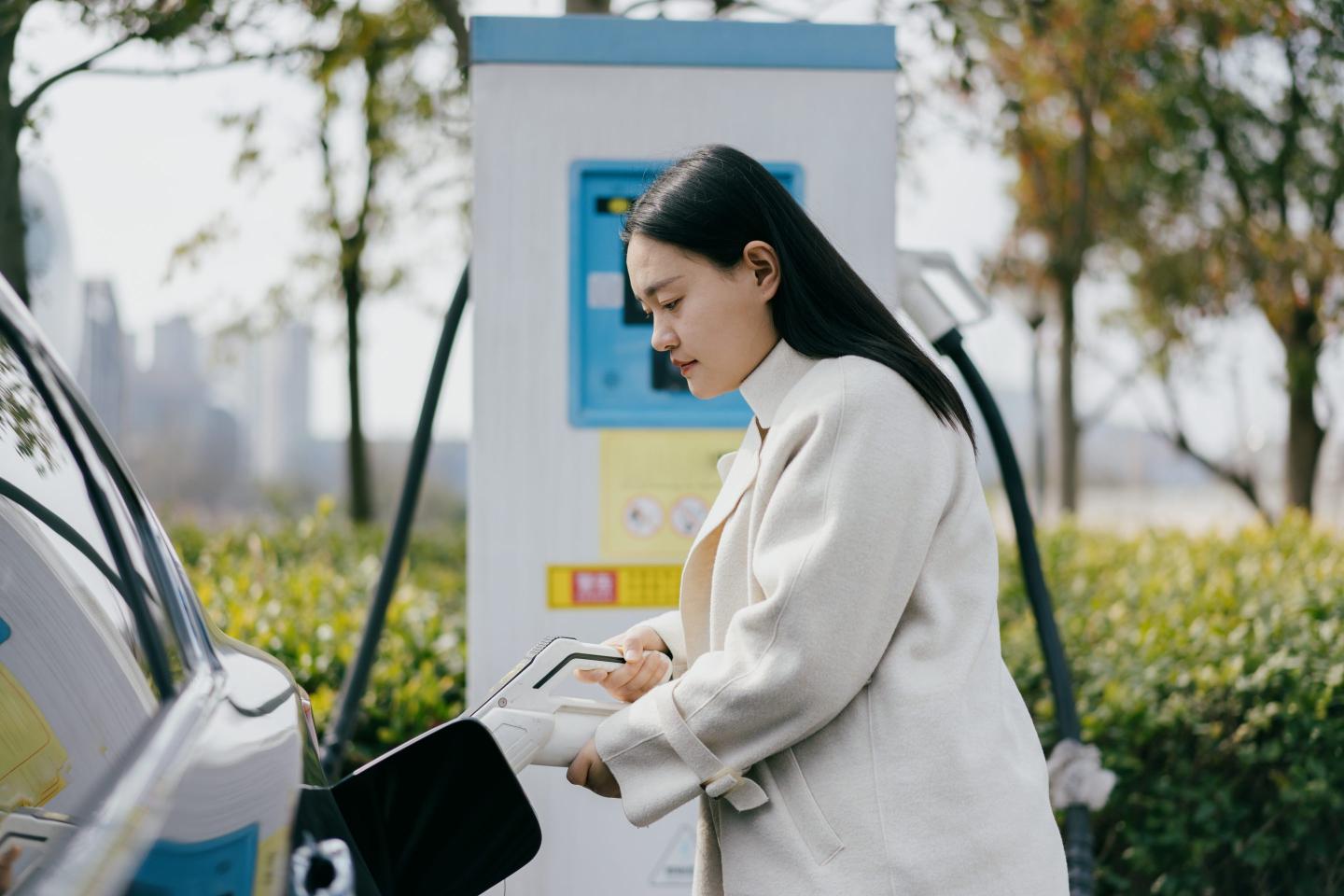 Woman charges her electric car