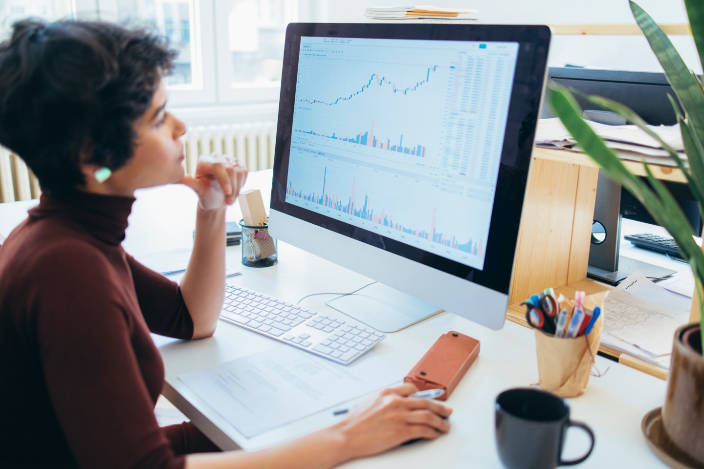 Young female examining the changes in the stock market at her office