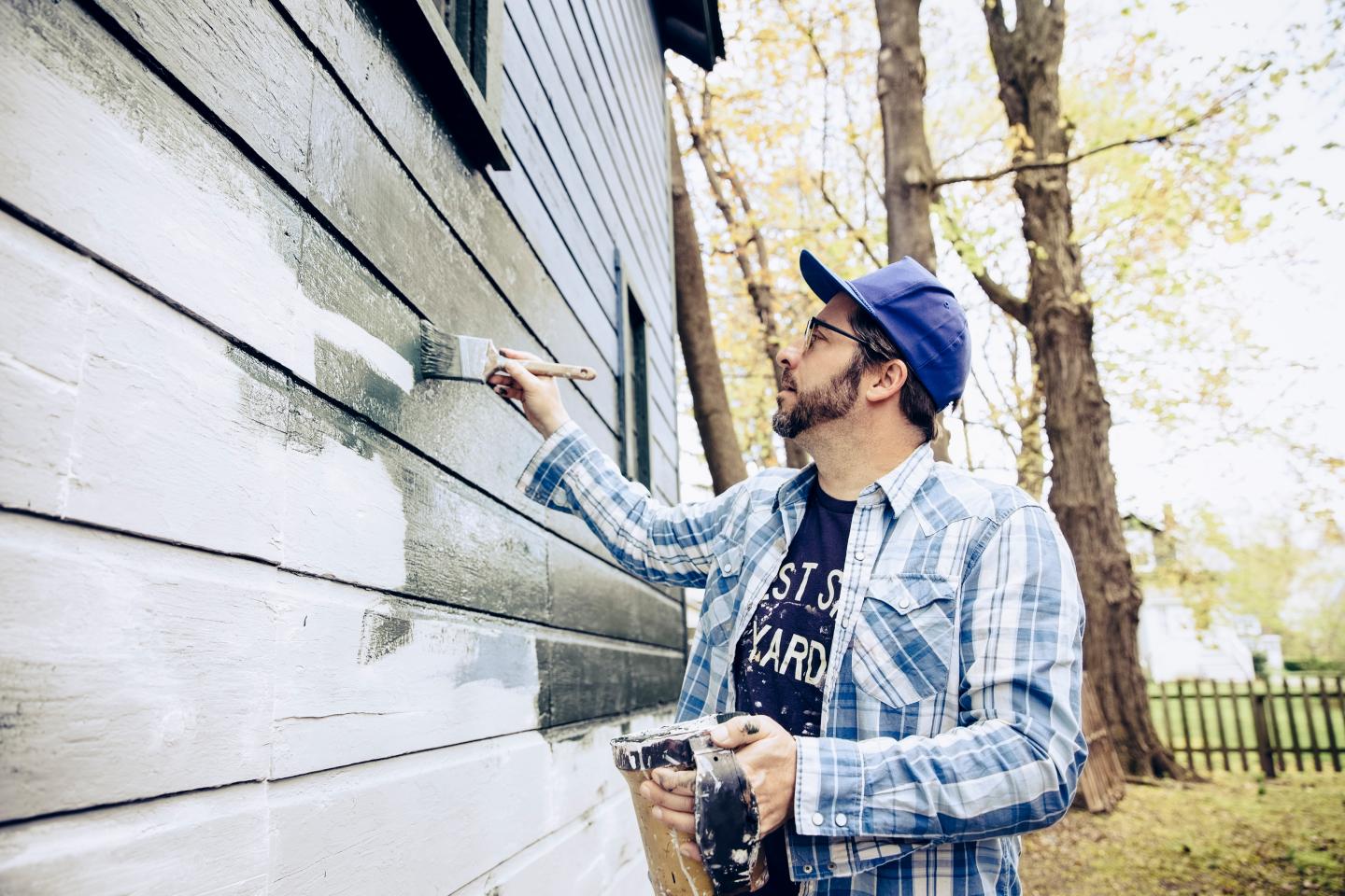 A man painting a home