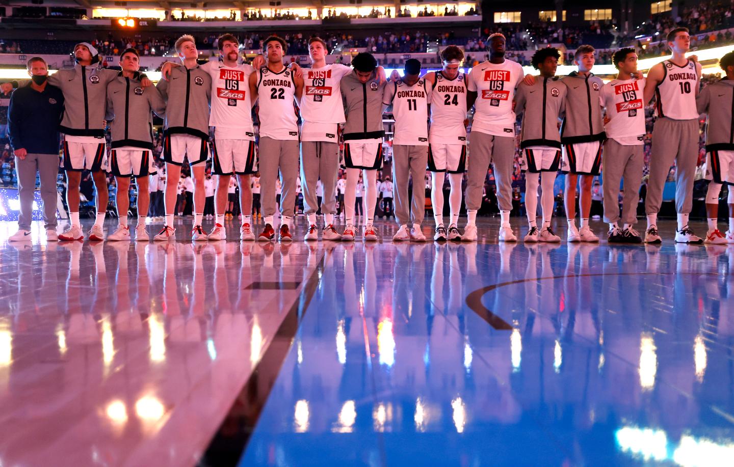 The Gonzaga Bulldogs stand for the national anthem ahead of the National Championship game of the 2021 NCAA Men's Basketball Tournament against the Baylor Bears at Lucas Oil Stadium on April 05, 2021, in Indianapolis, Indiana.