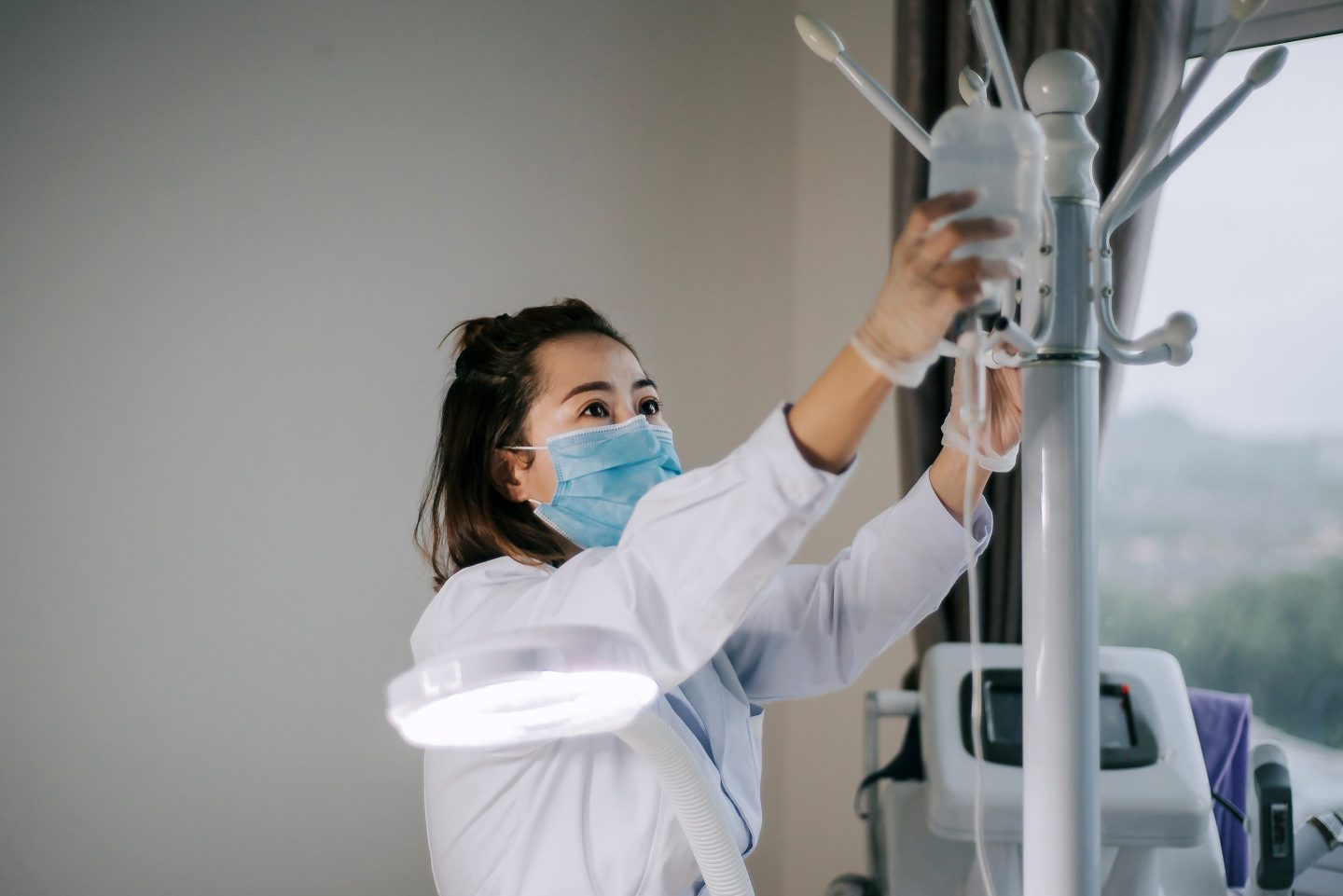 Female nurse holds and adjust saline injection