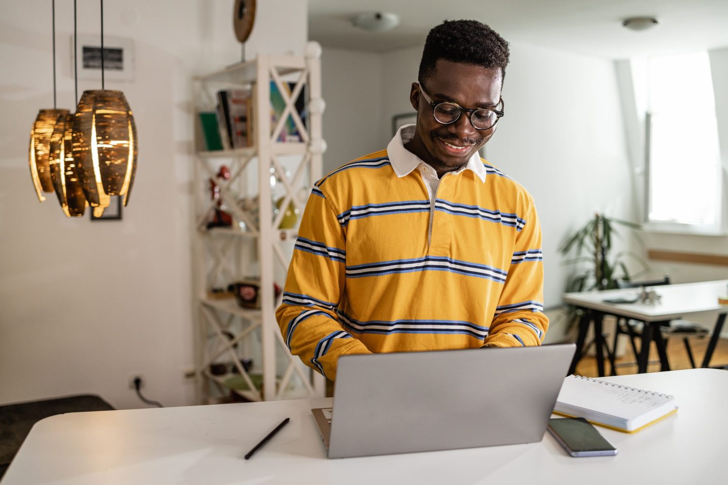 Black man working on laptop at home