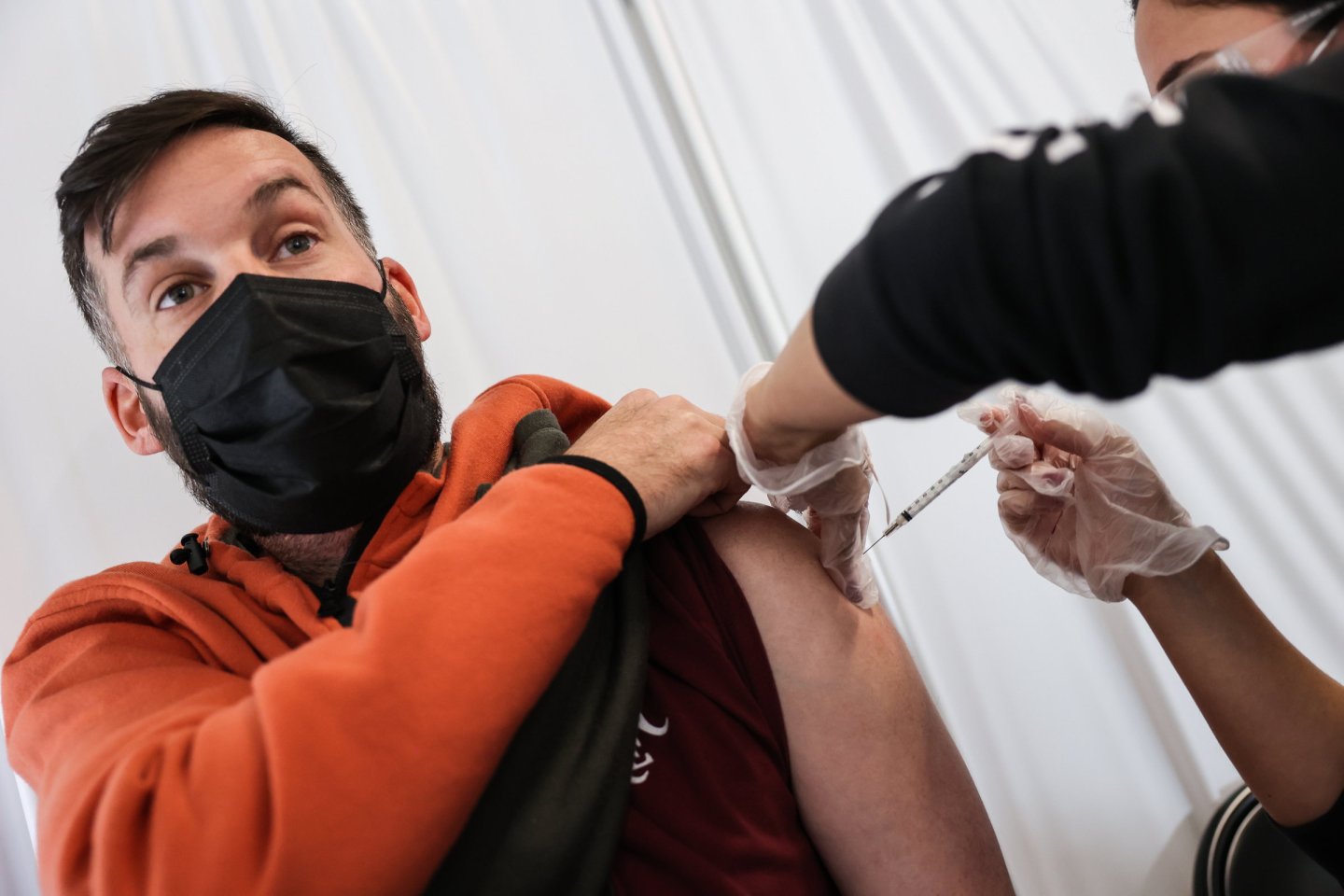 Man receiving a COVID vaccine booster shot in New York