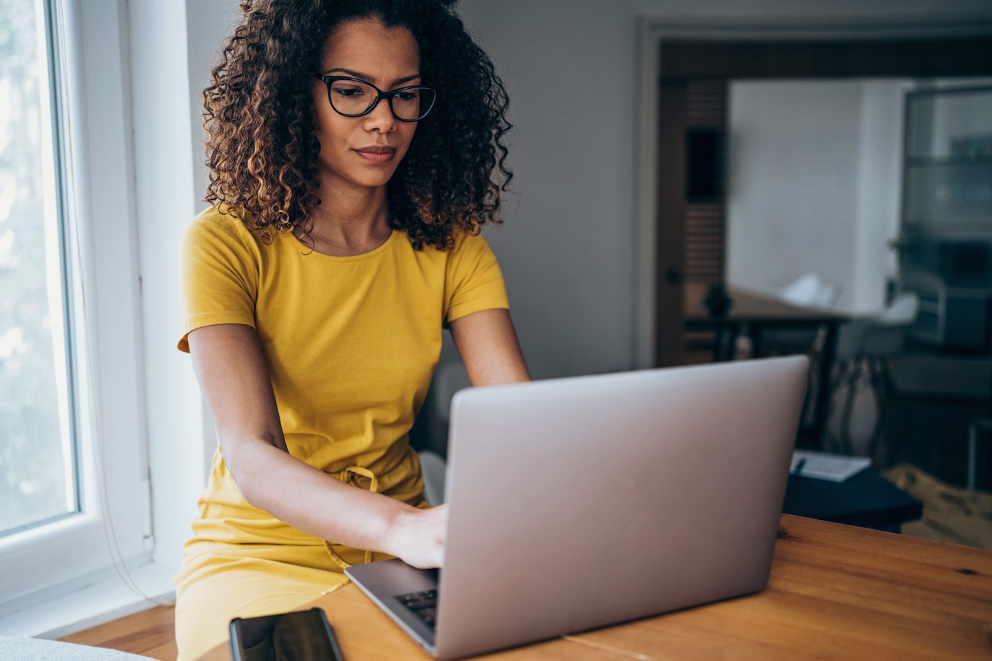 businesswoman in modern office working on laptop.