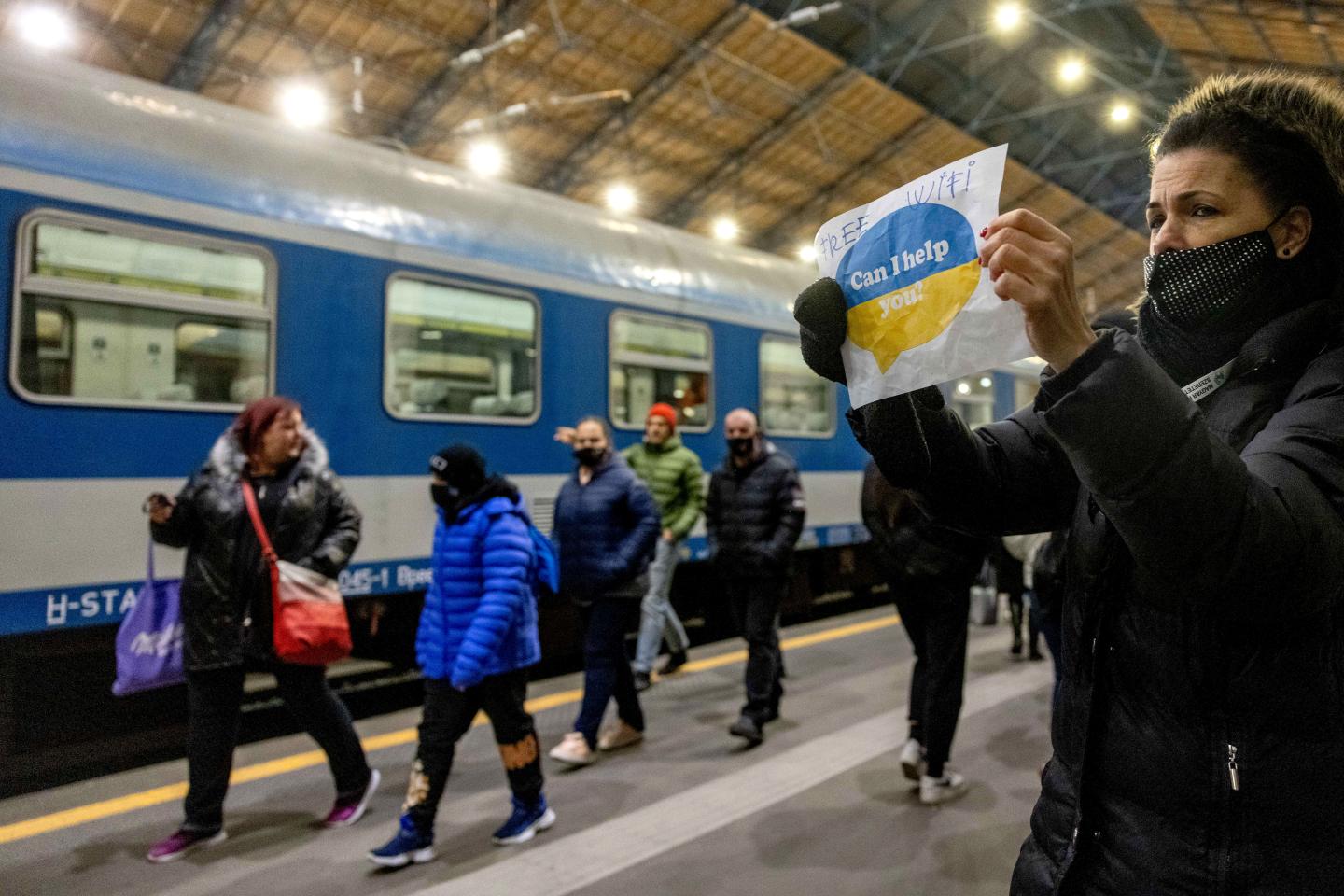 A woman offers help to arriving refugees at the Western Railway Station from Zahony after crossing the border at Zahony-Csap as they flee Ukraine on March 05, 2022, in Budapest, Hungary. Refugees from Ukraine have fled into neighboring countries such as Hungary, forming long queues at border crossings, after Russia began a large-scale attack on Ukraine earlier this week.