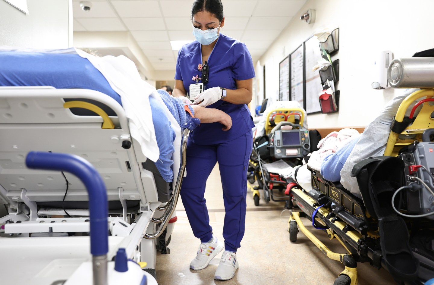 Lab technician Alejandra Sanchez cares for a patient in the Emergency Department at Providence St. Mary Medical Center on March 11 in Apple Valley, California. The hospital was treating 125 confirmed COVID-19 patients at the peak of the Omicron surge but has seen a sharp decline and is currently caring for 13 confirmed coronavirus patients.