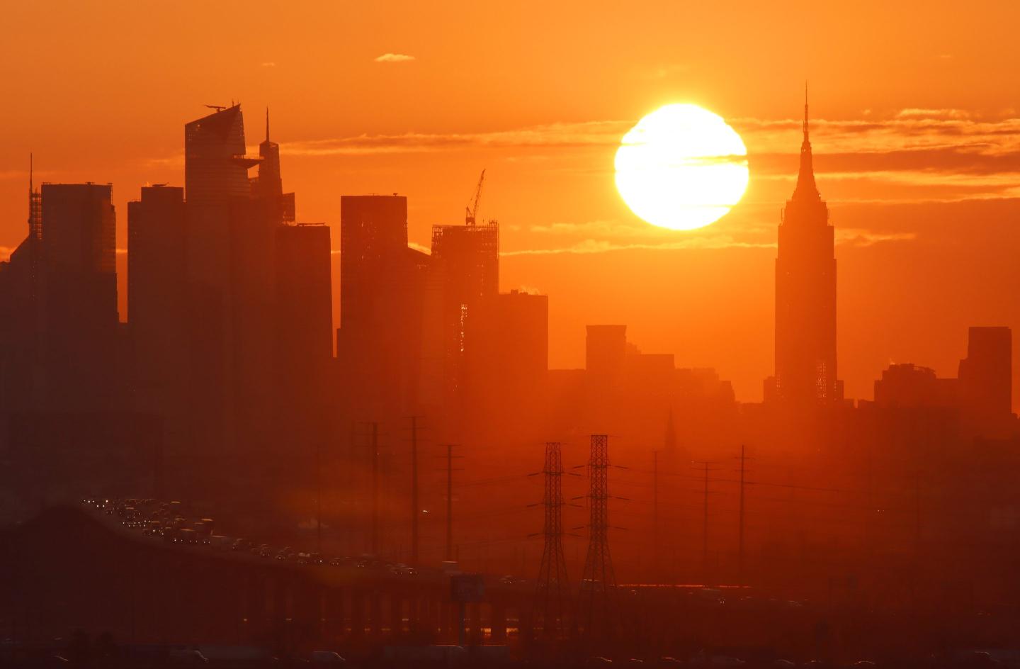 The sun rises over New York City