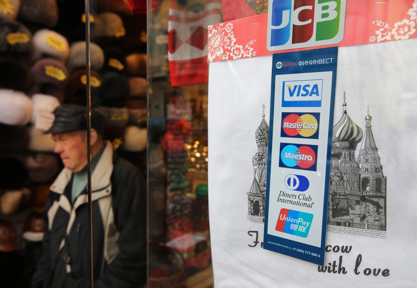 Photo of a shop sign in Moscow, Russia, displaying the logos of Visa, Mastercard and UnionPay.