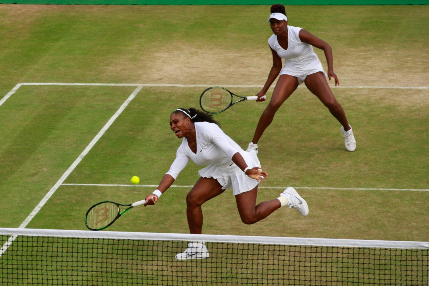 Serena and Venus Williams playing Tennis during the Ladies Doubles Quarter Finals match