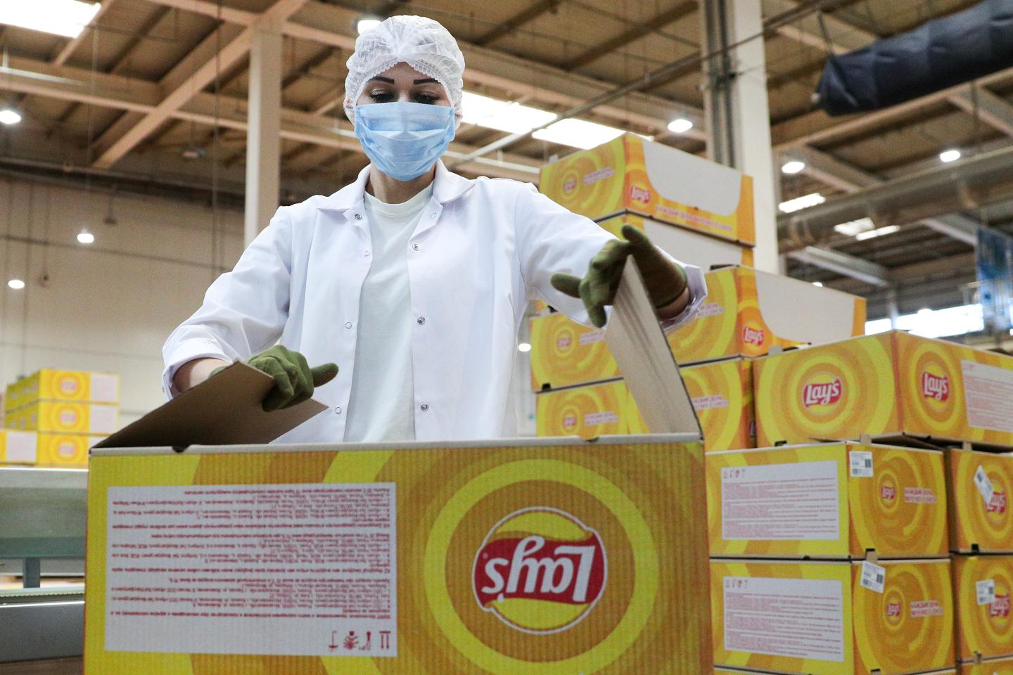 A worker packs finished products into boxes at a PepsiCo plant in Russia.