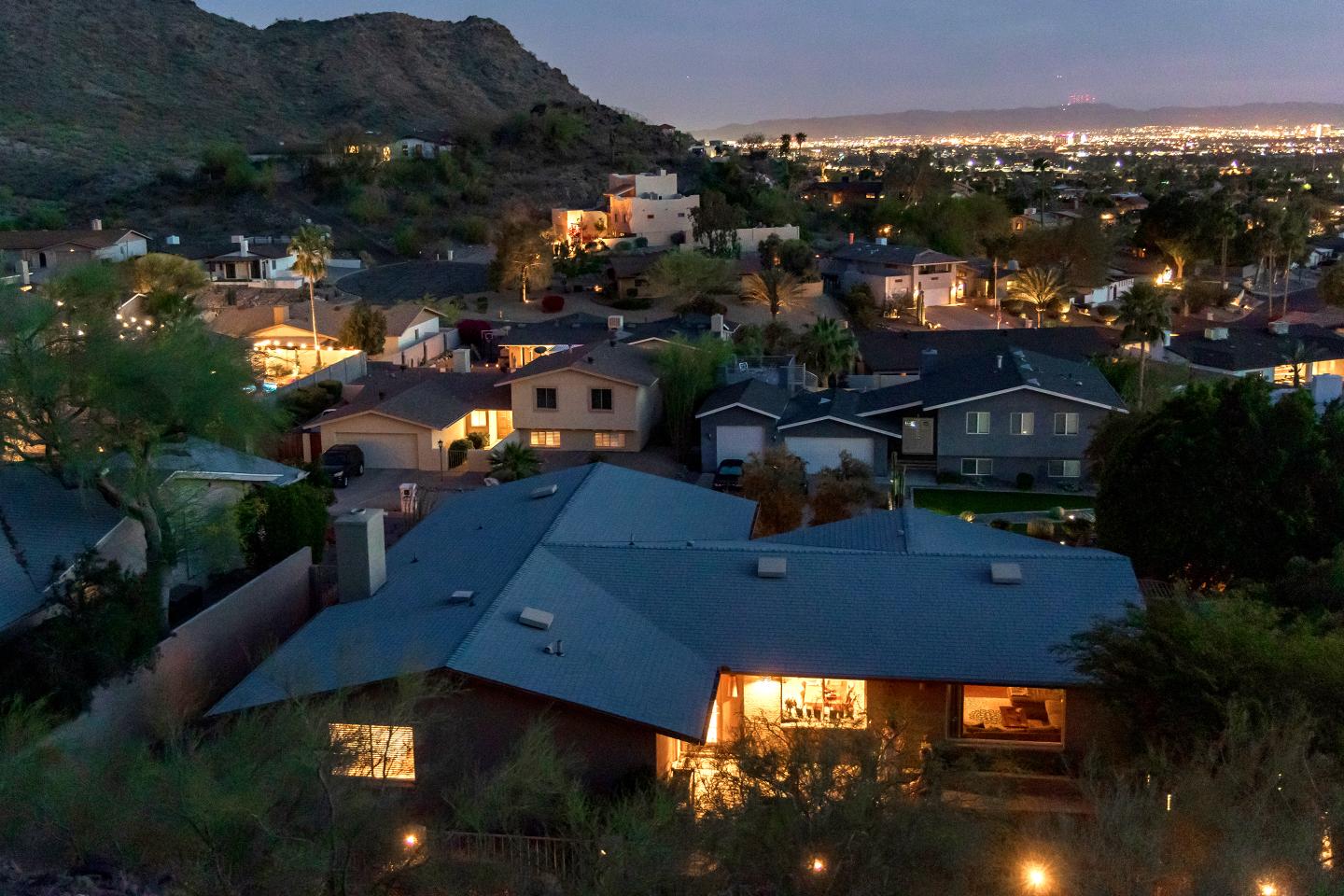 A mountain overlook of a Phoenix, Arizona neighborhood at dusk.